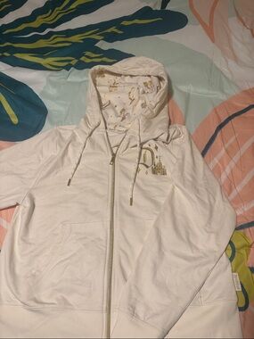 Disneyland 70th birthday Cream Zip Hoodie with Gold Castle Accents.
